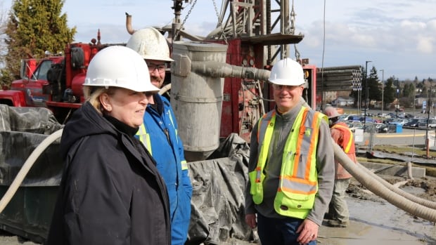 University officials and Falcon Engineering geo-exchange engineer Jeff Quibell, right, view progress on the project, which has attracted interest from as far as Scotland.
