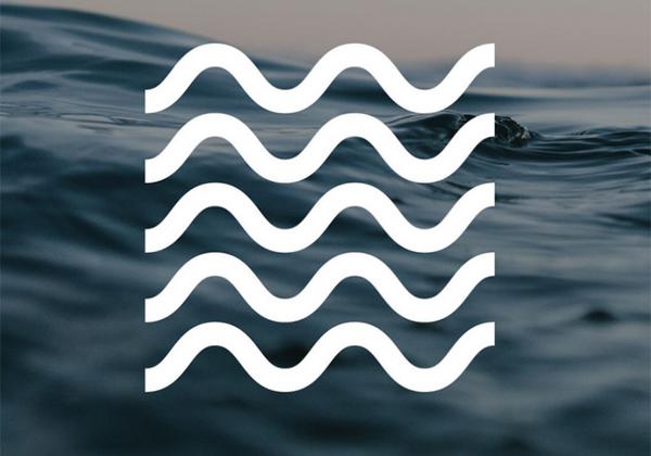 White wave icon over photo of ocean.