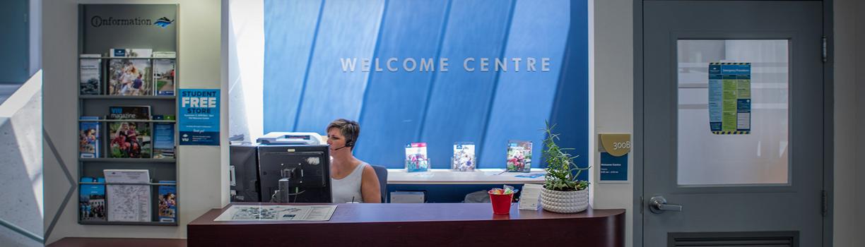 VIU employee answering the phone in the Welcome Centre